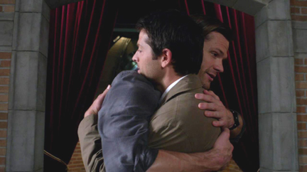 Sam gives Cas a hug.